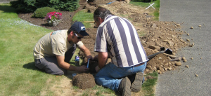 two of our Deerfield Beach irrigation repair techs are working on a sprinkler repair